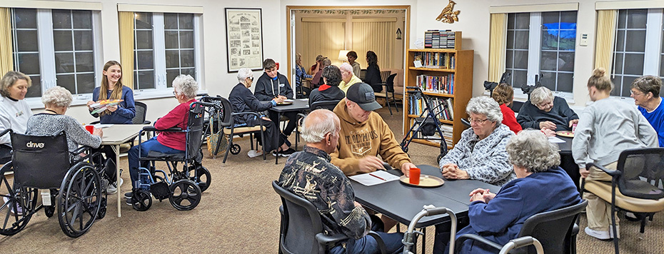 Pines residents play Bunco with confirmation students from St. John's Lutheran School.